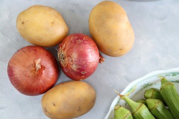 Raw Green Organic Okra or ladies finger Vegetables Ready to Cook with Onion, potatoes, chilies, garlic and Indian Species like Red chili powder, Turmeric powder, black pepper and cumin seeds