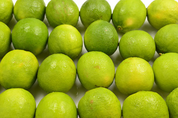 Many fresh limes on white background.