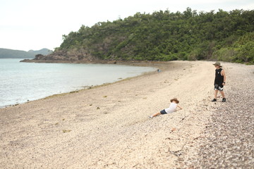 Boys playing on the beach in the Whitsundays, Queensland Australia