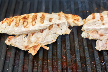 Grilled cooking. Grilled chicken breast lies on the grill.
