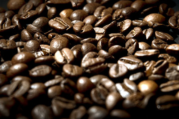 Coffee beans on a dark background. Photo in the dark