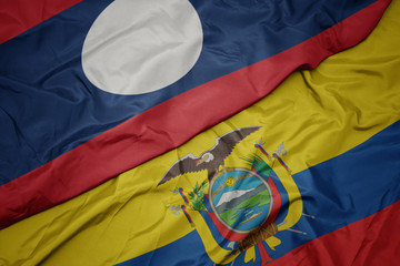 waving colorful flag of ecuador and national flag of laos.