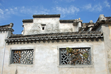 Xidi Ancient Town in Anhui Province, China. A quiet street in the old town of Xidi called the Back Rivulet. Detail of a wall and tiling of a local house. Traditional architecture in Xidi, China.