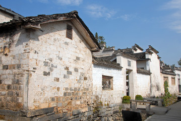 Fototapeta na wymiar Xidi Ancient Town in Anhui Province, China. A quiet street in the old town of Xidi called the Back Rivulet. This path follows a small stream past local houses. Traditional architecture in Xidi, China.