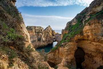 Scenic natural cliff formations and arches of Algarve coastline with turquoise water at Ponta da Piedade, in Algarve Portugal