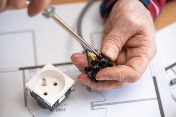 Electrician connecting wires in terminal block