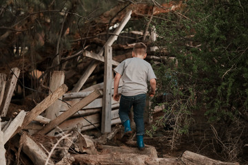 Two boys exploring run down farm