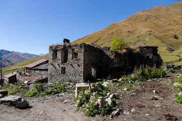 Fototapeta na wymiar View of the village of Ushguli in a beautiful autumn landscape with white clouds in Svaneti. Georgia