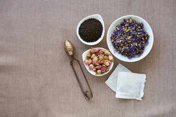Different types of dry tea on a brown background