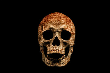 Scary rusty skull isolated on black background.