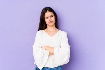 Young caucasian woman isolated on purple background tired of a repetitive task.