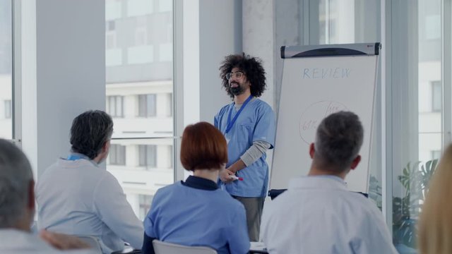 Group of doctors listening to presentation on medical conference.