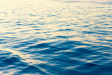 Surface of a calm blue sea. Selective focus. Shallow depth of field. Toned