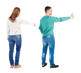 Back view of couple couple in sweater pointing.