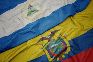 waving colorful flag of ecuador and national flag of nicaragua.