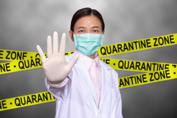 Asian female doctor wear a medical mask, raise hand for stop sign to do not enter quarantine area...