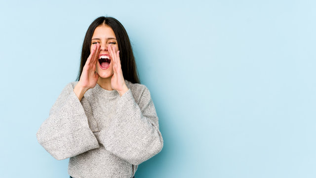 Young Caucasian Woman Isolated On Blue Background Shouting Excited To Front.