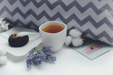 good morning with tea and a lavender bouquet of flowers on a white background