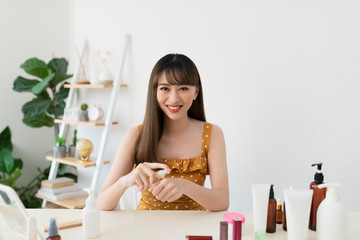 woman applying spray water treatment on hand in live at home