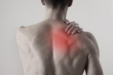Naklejka premium Man suffering from back and neck pain. Chiropractic concept. Sport exercising injury