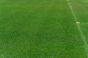 orange pitch mark on football green grass field background