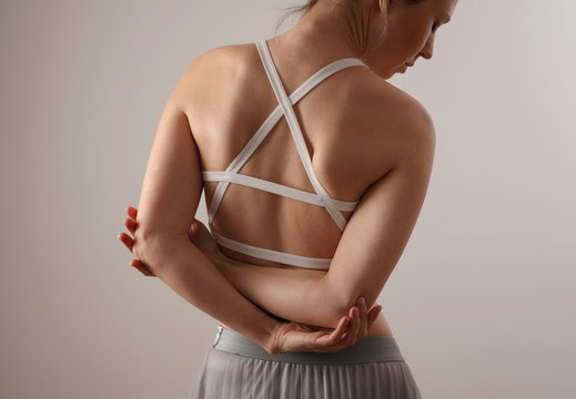 Woman suffering from back and pain. Scoliosis posture correction, muscles straching,ballet body exercises