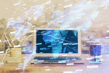 Double exposure of laptop computer and technology theme hologram. Concept of freelance work.