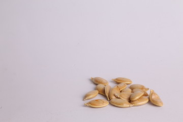 pumpkin seeds on color background