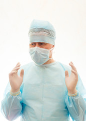 Fototapeta na wymiar Right positioned hands of ready to work surgeon in sterile gown, mask and gloves
