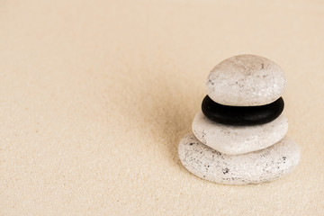 Fototapeta na wymiar Close up view of zen stones on sand surface