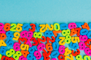 Top view of colorful numbers on blue background