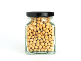 Soybeans in glass jar isolated on white background.