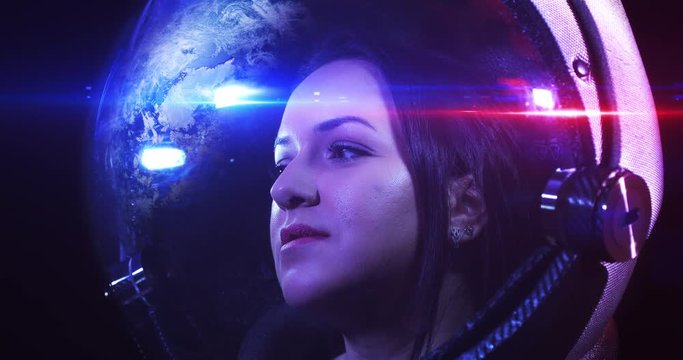 Portrait 4K Shot Of The Young Smiling Female Astronaut In Space Helmet. She Is Exploring Outer Space In A Space Suit. Science And Technology Related 4K Concept Footage.