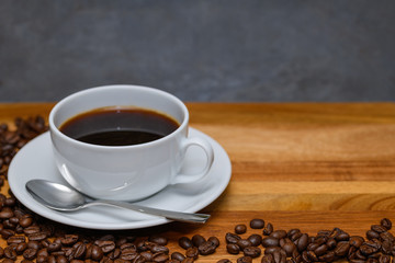 Delicious cup of coffee on dark wood with copy space