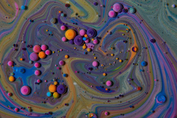Macro photography of colorful bubbles on some fluids that seems to be some kind of unknown worlds.