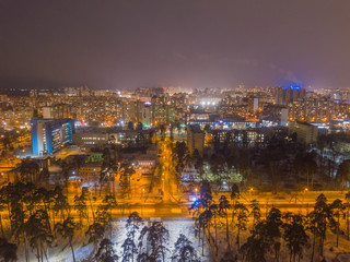 Aerial drone view. Evening illumination of the snowy city of Kiev.