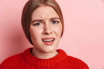 Confused emotional young woman posing isolated