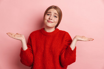 Confused emotional young woman posing isolated