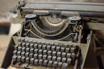 Old, antique typewriter close-up in the dust.
