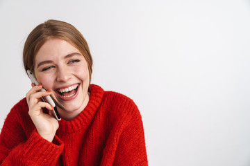 Happy young woman talking by mobile phone.