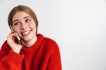 Happy young woman talking by mobile phone.