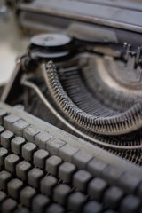 Old, antique typewriter close-up in the dust.