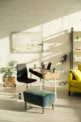 Living room with laptop on table and crutches near wall