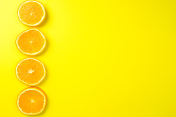 Fresh slice of orange on yellow background. Citrus, vitamin concept