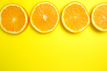 Fresh slice of orange on yellow background. Citrus, vitamin concept