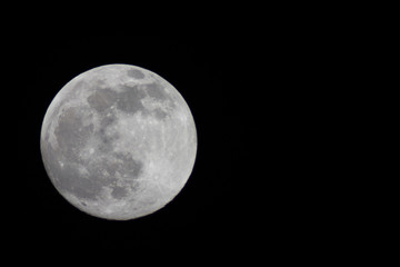 Naklejka na ściany i meble Full moon through a telescope on a dark night