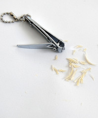 Fingernails and nail clippers on white ground, personal care and cleaning,