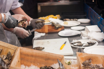 Fresh oysters with lemons in the street market.