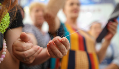 People hold silk fibers in a factory.