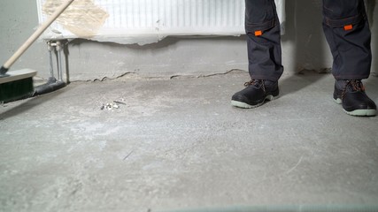 Concrete floor is prepared for repair. Concrete floor in the apartment. Unfinished building interior, empty room with conditioning canals